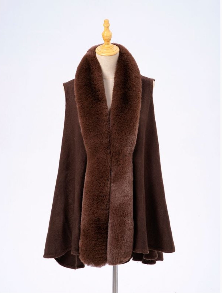 Brown fur-collared cape on a mannequin.