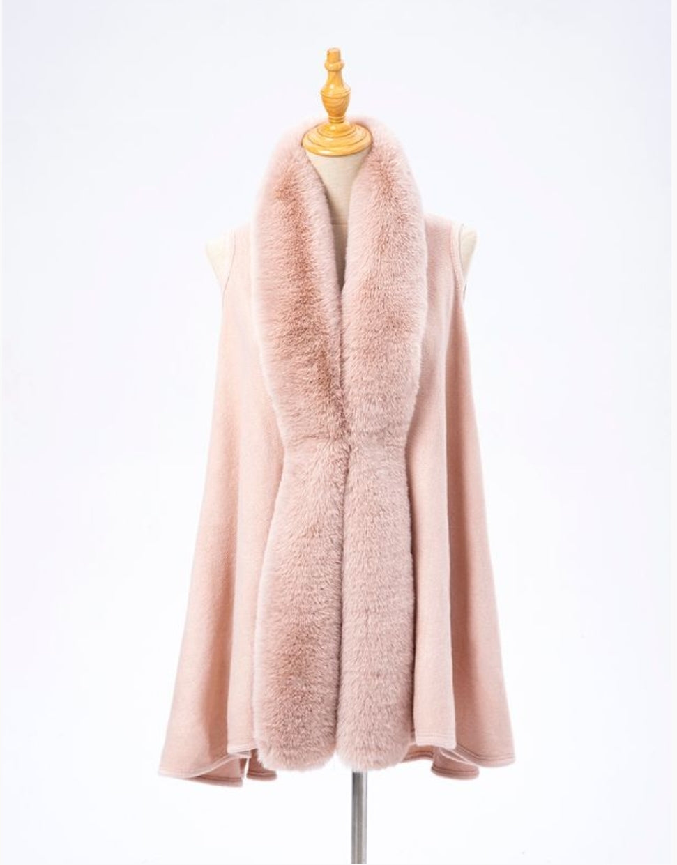 Pink cape with fur collar on a mannequin.