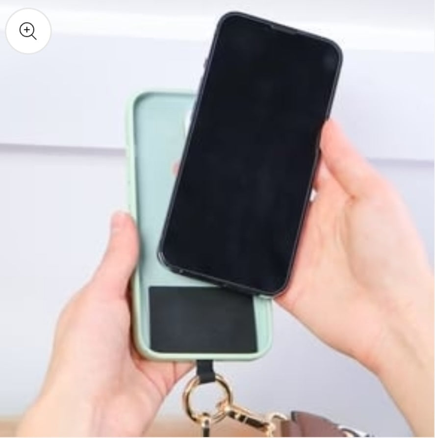 Hands holding a phone and case.