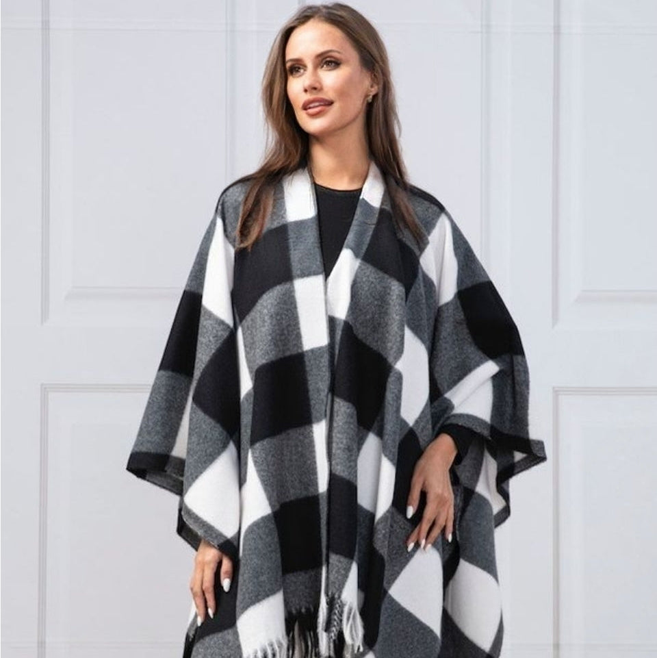 Woman wearing a black and white checkered poncho.