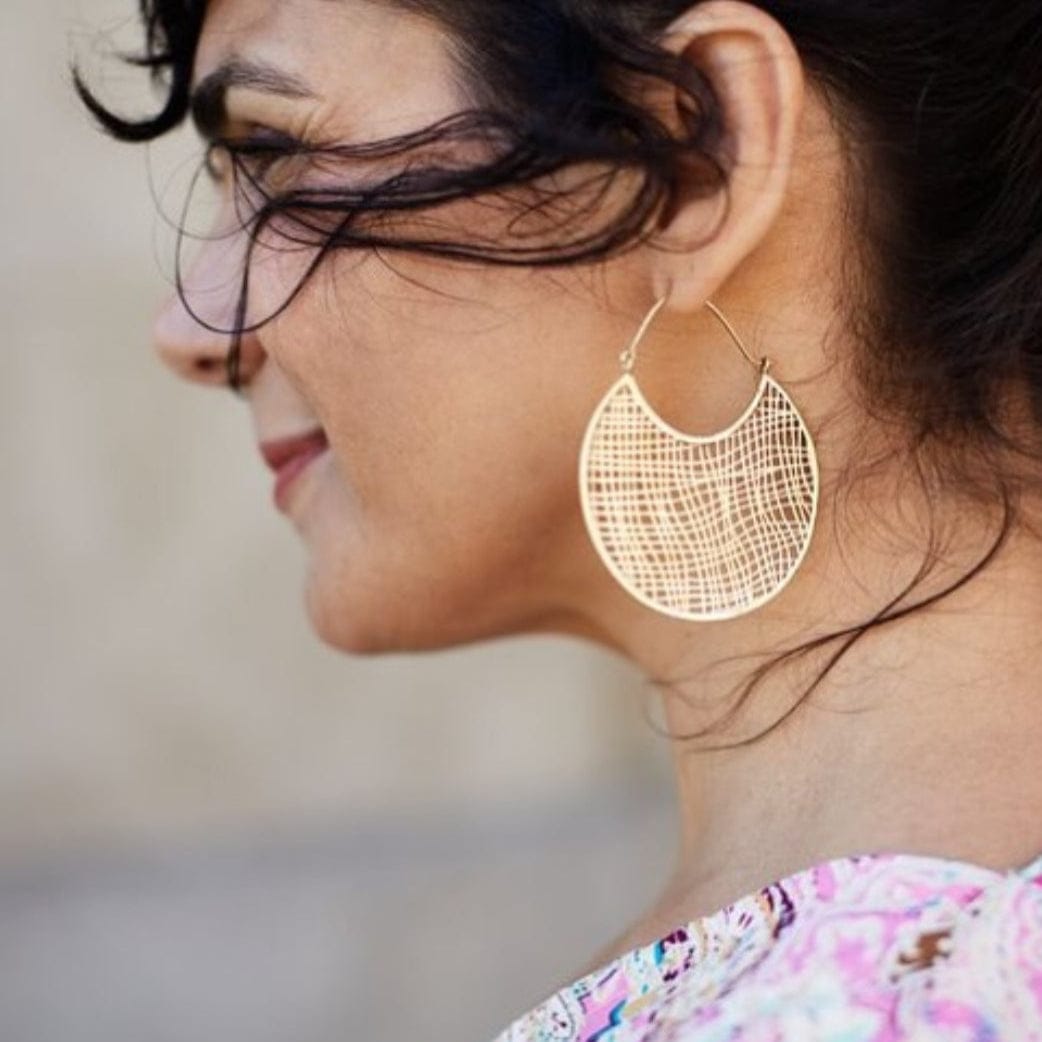 Woman wearing gold filigree earrings