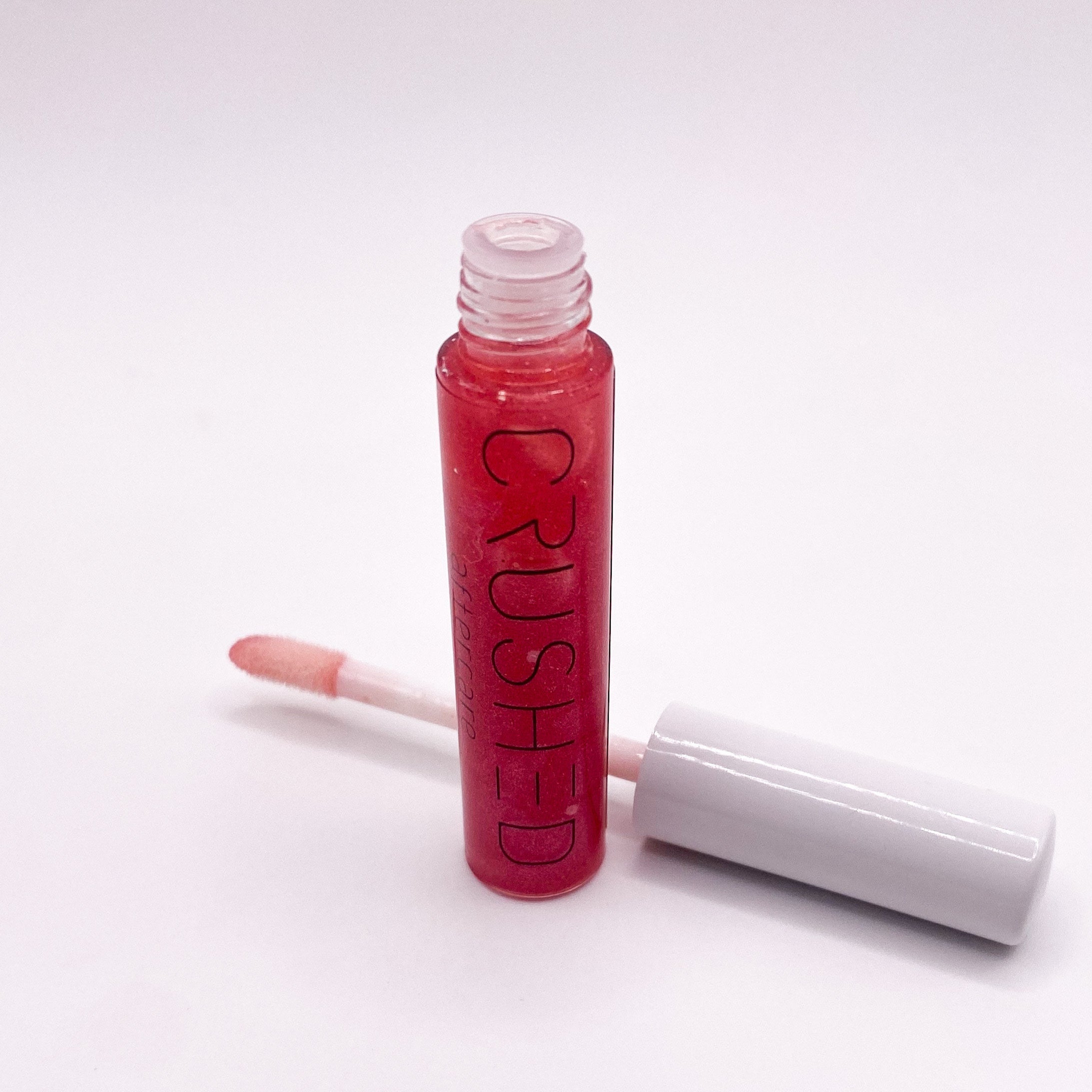 Red lip gloss tube with applicator.