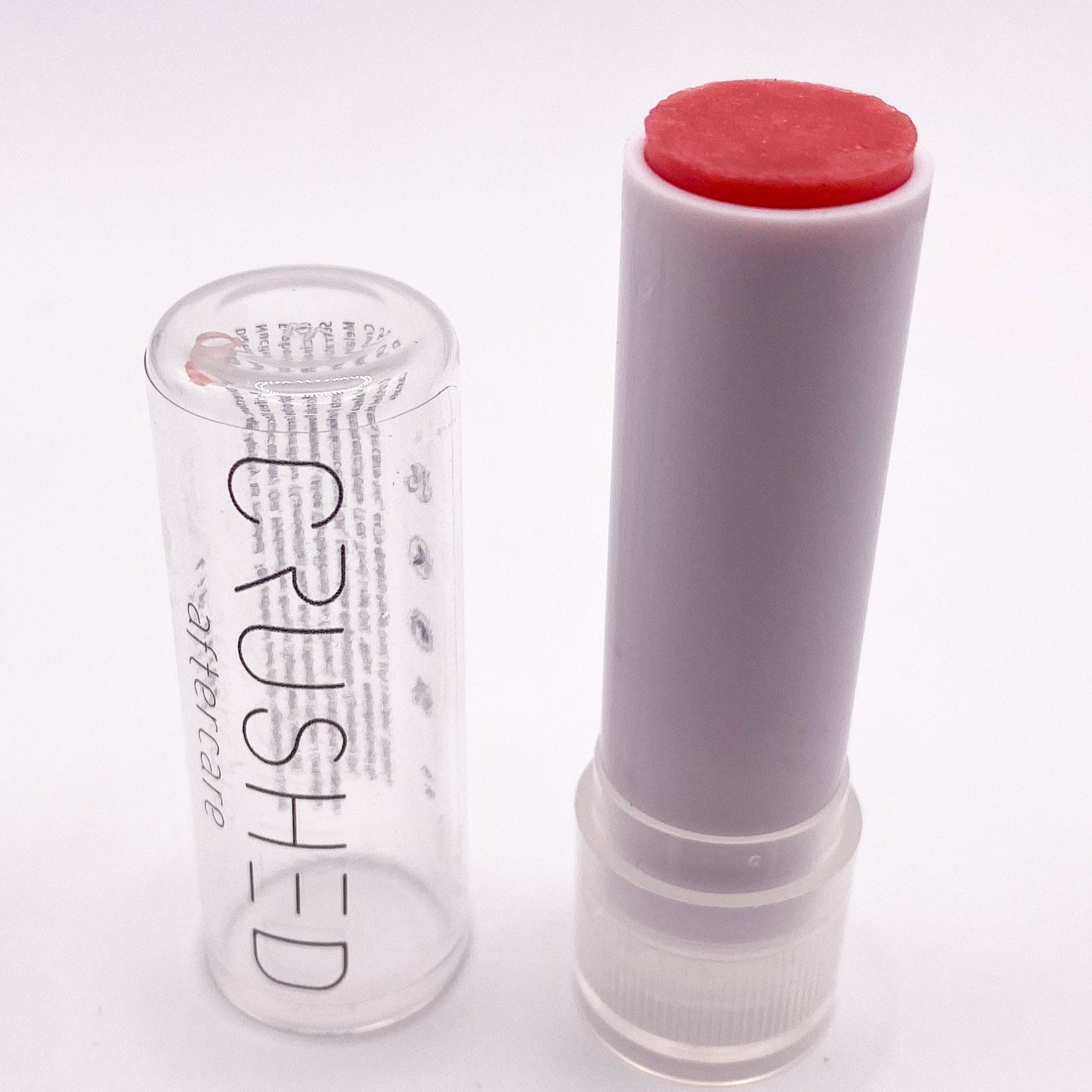 Open lipstick tube next to empty case.