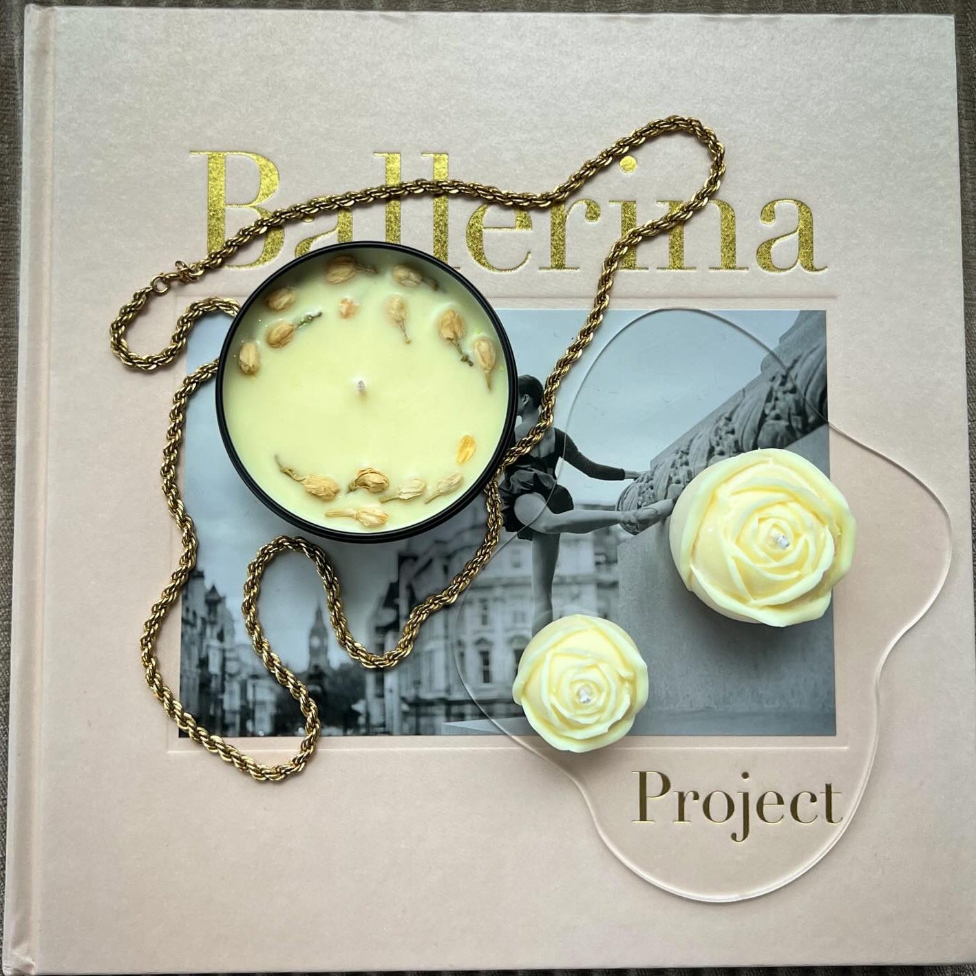 Midnight Jasmine candle on ballerina book with necklace and roses