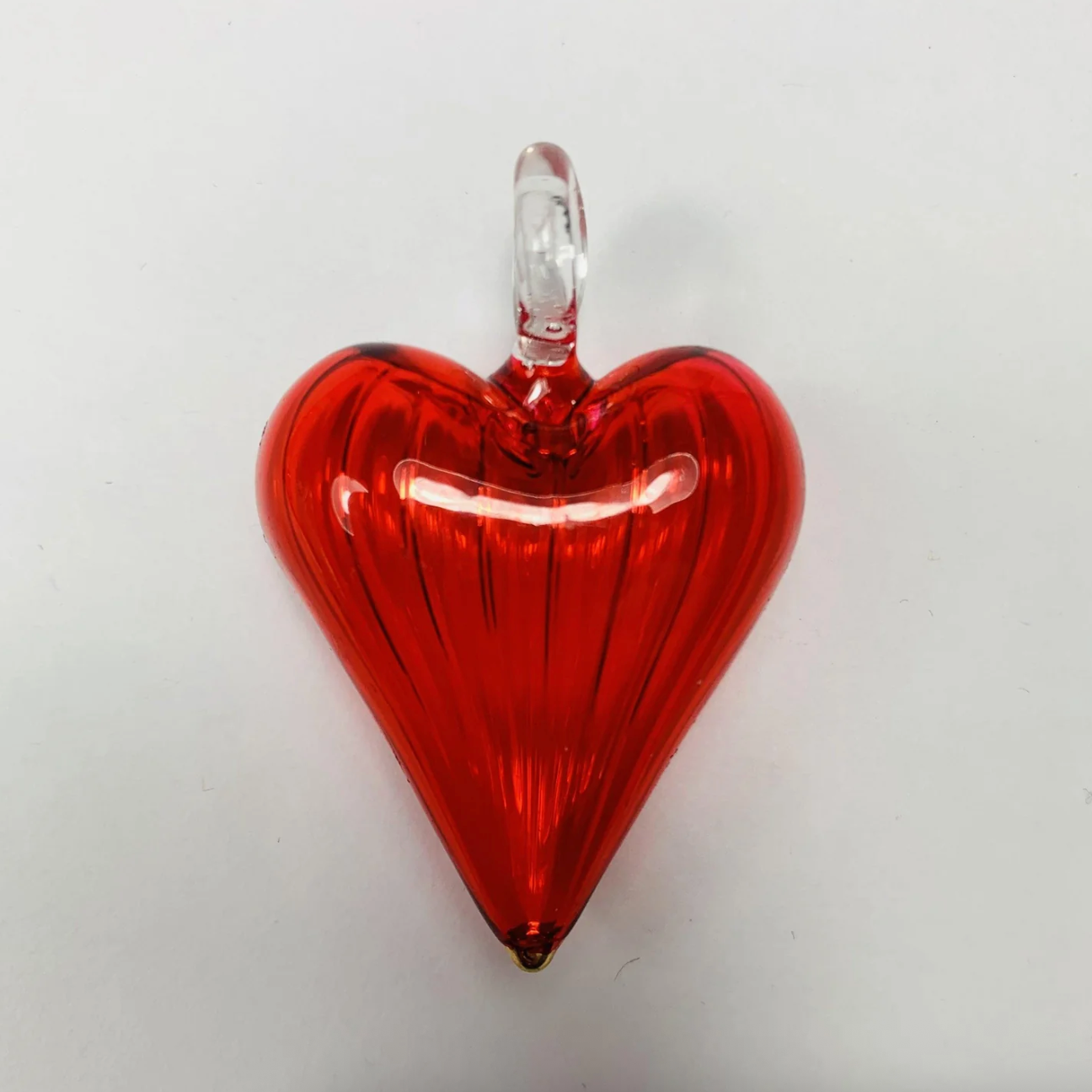 Screenshot of red glass heart pendant, June 30, 2025.