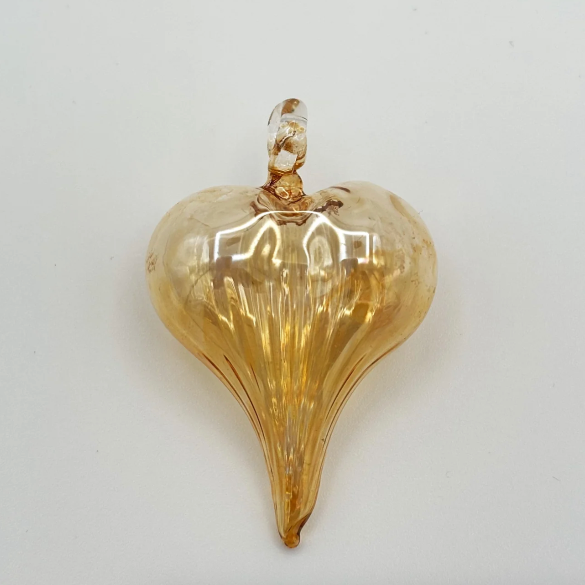 Screenshot of a gold heart-shaped glass ornament, June 30, 2025.