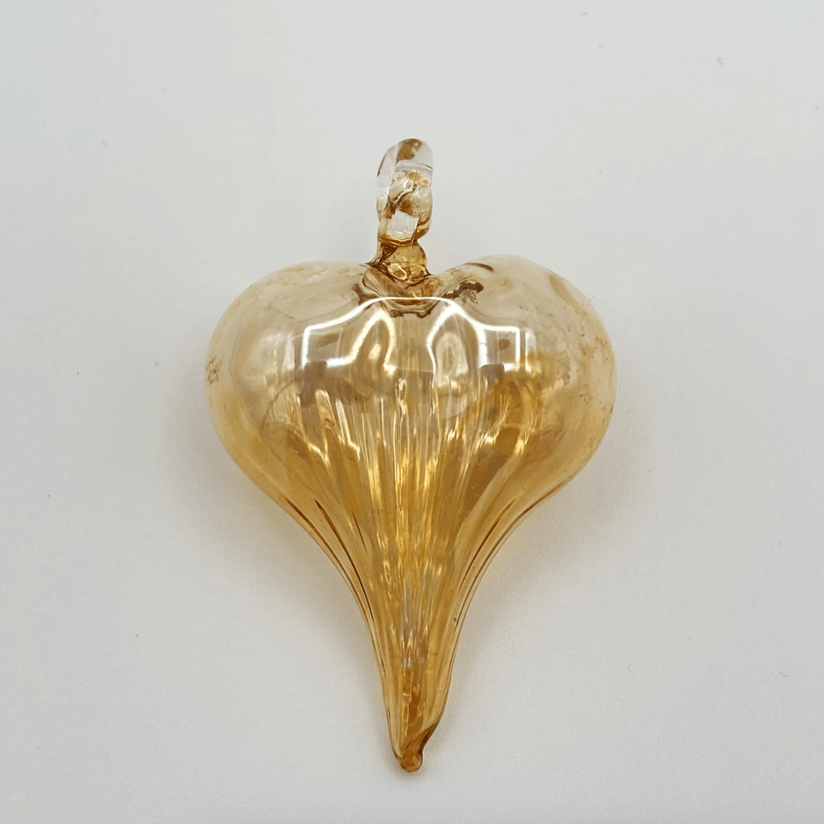 Screenshot of a gold heart-shaped glass ornament, June 30, 2025.