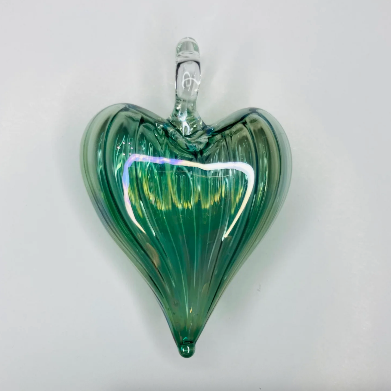 Green glass heart ornament, screenshot from June 30, 2025.