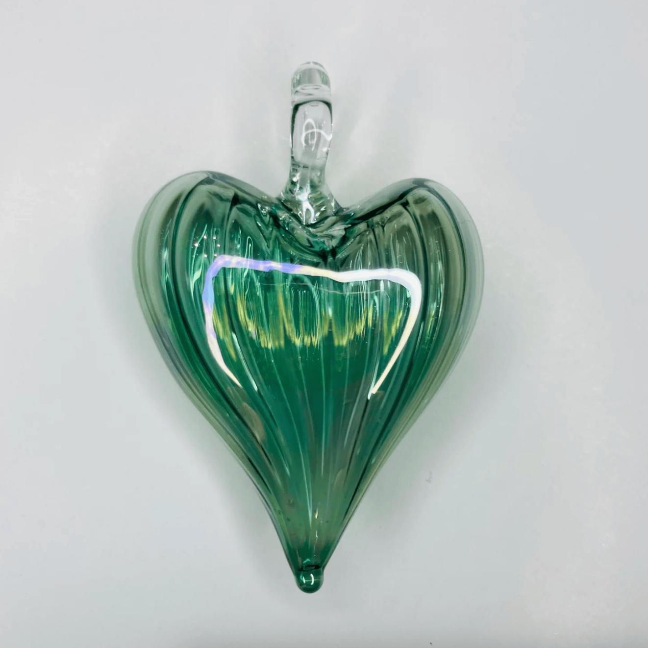 Green glass heart ornament, screenshot from June 30, 2025.