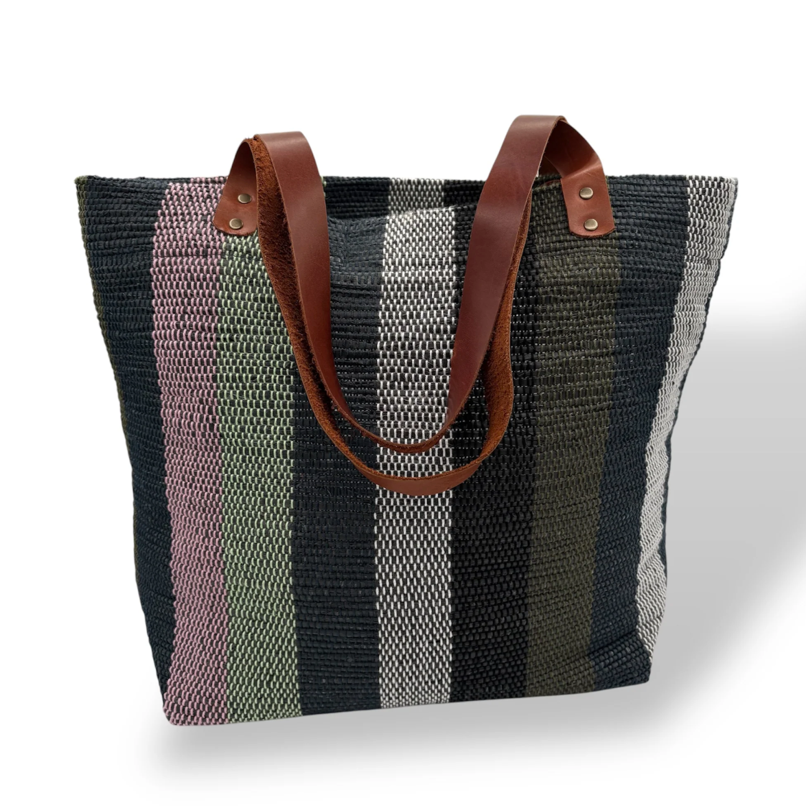Striped tote bag with leather handles, seen on June 30, 2025.