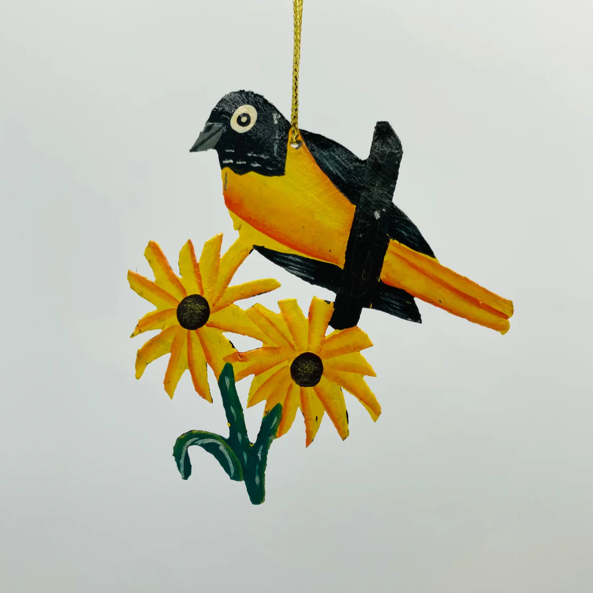 Wooden Baltimore oriole ornament on sunflowers - Screenshot June 30, 2025