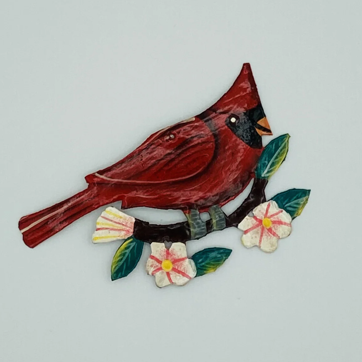 Screenshot of a red cardinal bird on a flowering branch.