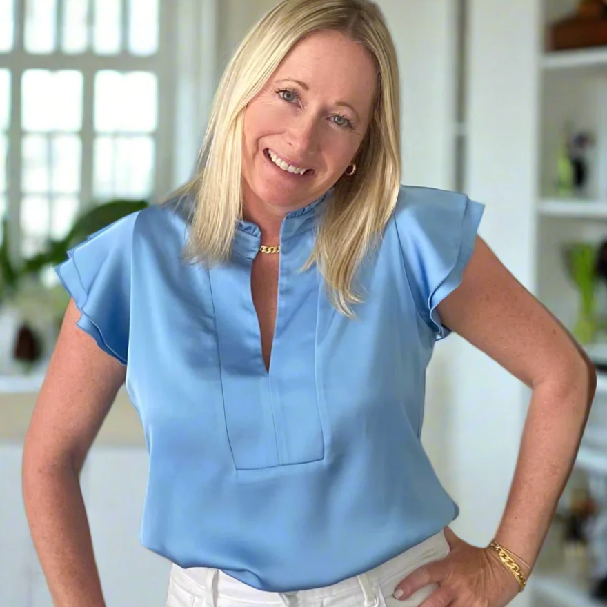 Woman in blue top, screenshot July 9, 2025