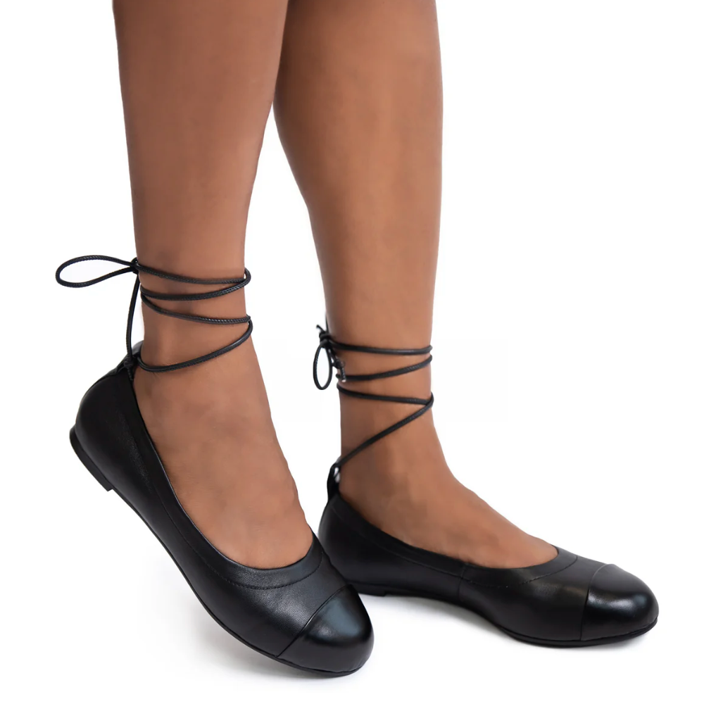 Black ballet flats with ankle ties.