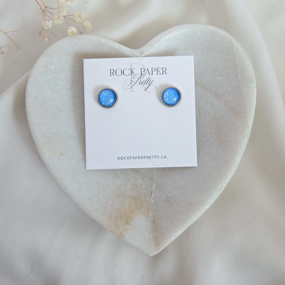 Blue stud earrings on heart-shaped tray, July 21, 2025 screenshot.