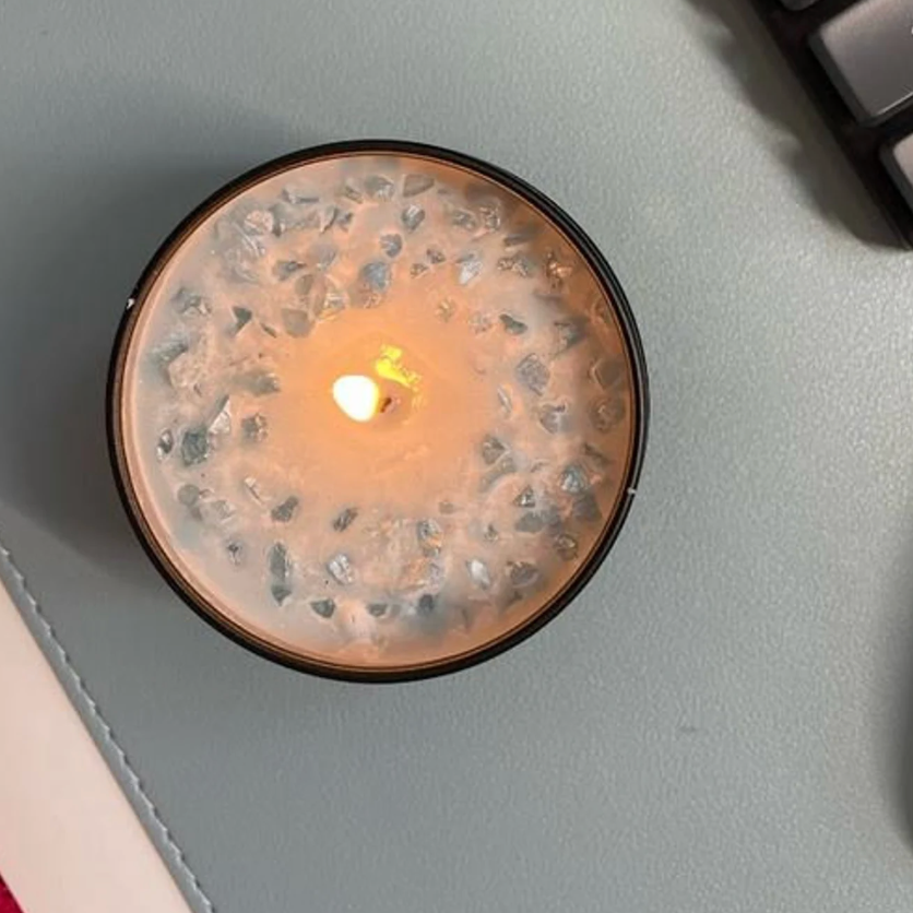 Candle with crystals lit, screenshot July 22, 2025