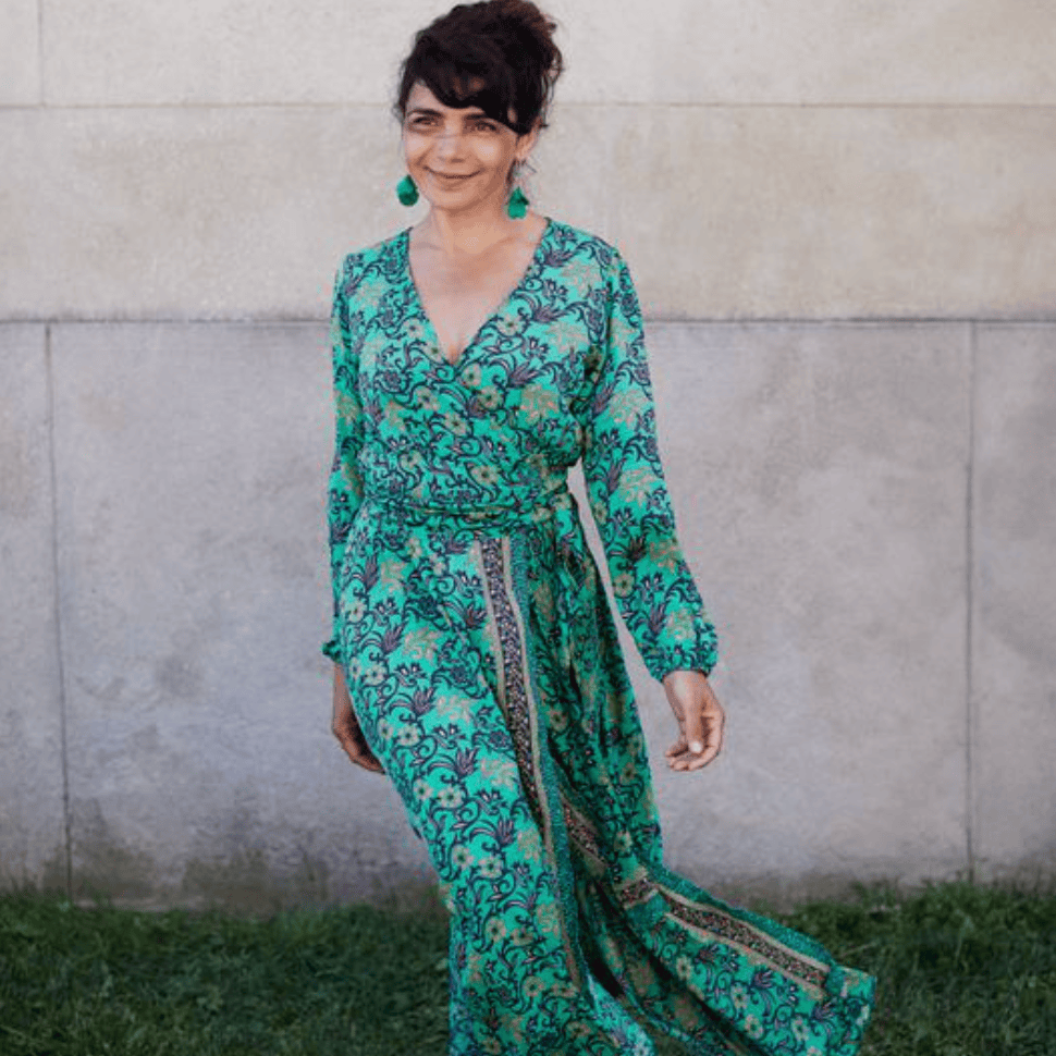 Woman in green floral dress, screenshot August 16, 2025