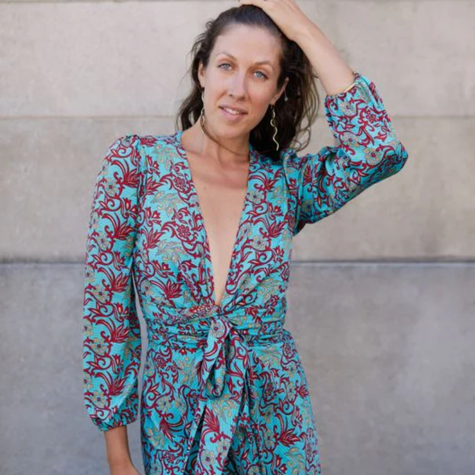 Woman in patterned dress, screenshot August 16, 2025