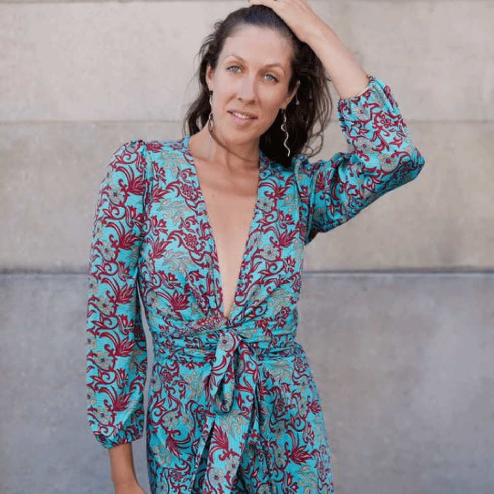 Woman in patterned dress, screenshot August 16, 2025