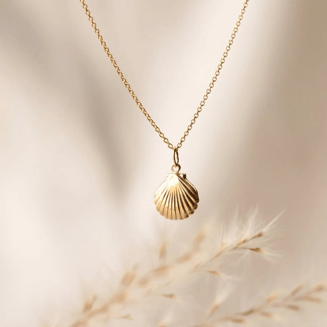 Golden seashell pendant necklace, screenshot August 27, 2025.