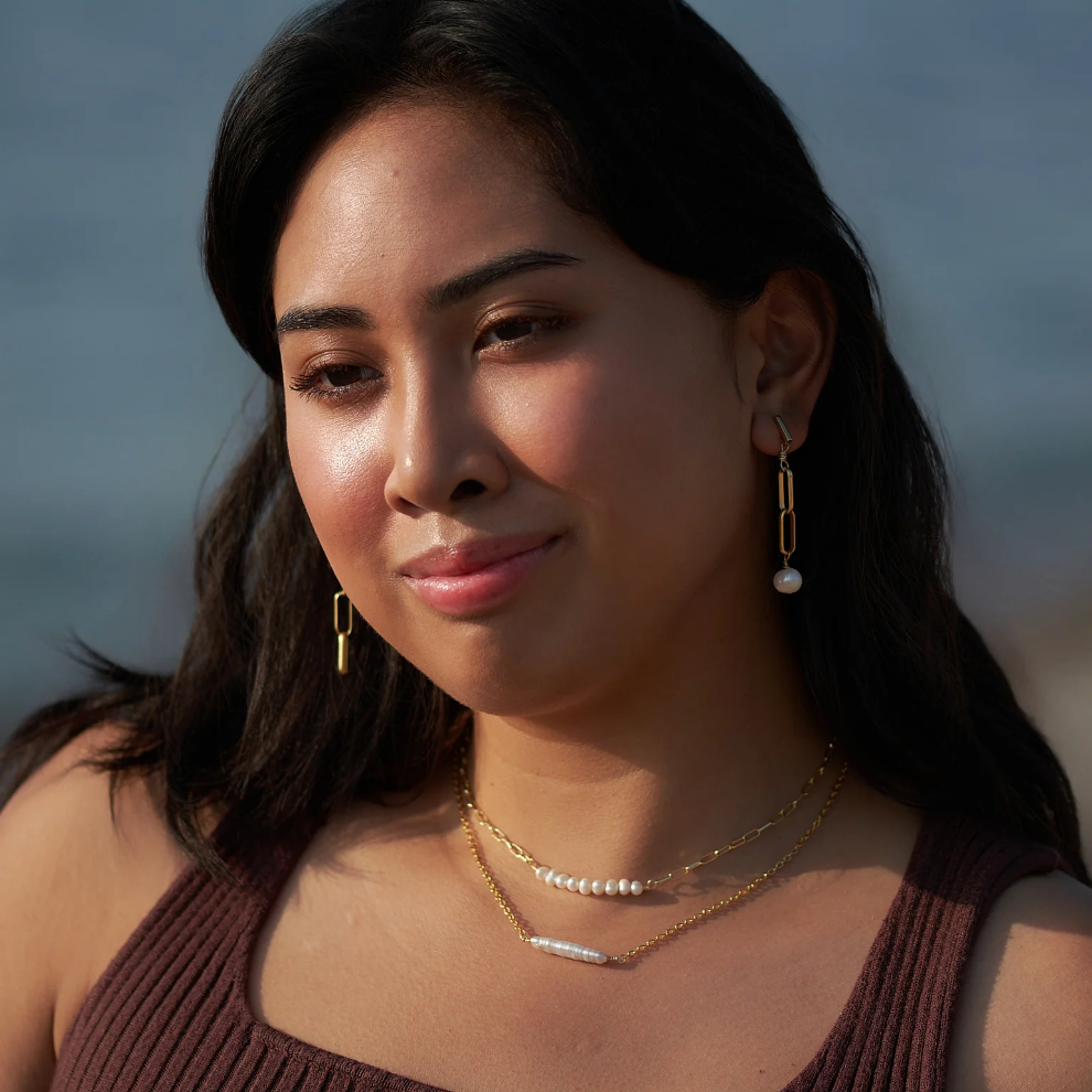 Woman wearing pearl jewelry, screenshot Sept 4, 2025.