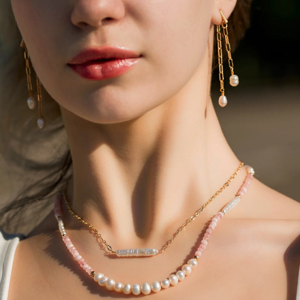 Woman wearing pearl jewelry, screenshot 2025-09-04