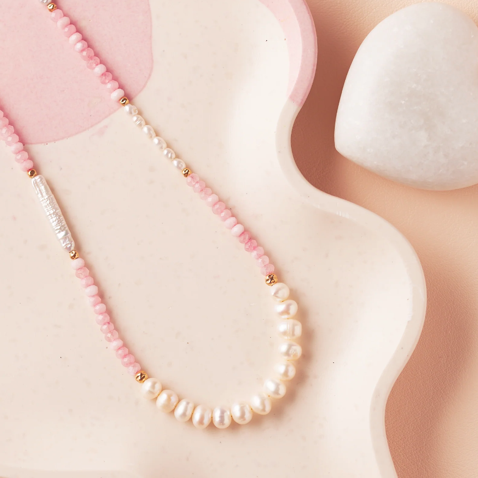 Pink and pearl necklace on a tray - Screenshot Sept 4, 2025