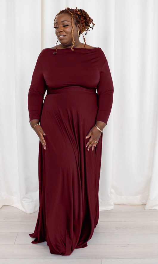 Woman in burgundy maxi dress, screenshot Sept 6, 2025