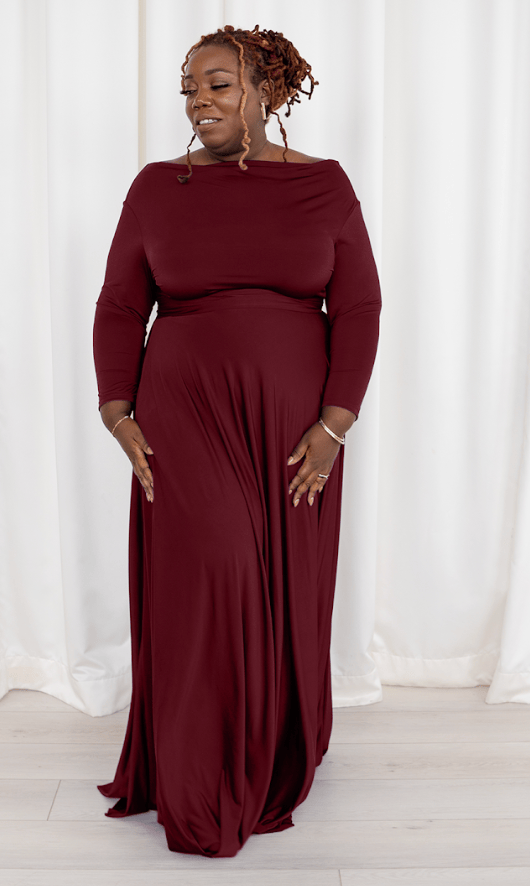 Woman in burgundy maxi dress, screenshot Sept 6, 2025