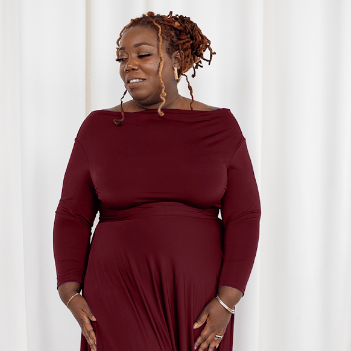 Woman in maroon dress, screenshot from September 6, 2025.