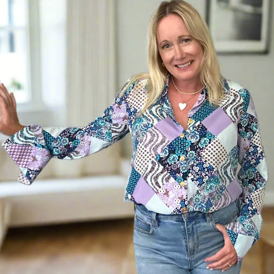 Woman in patchwork shirt smiling, Screenshot Sept 9, 2025