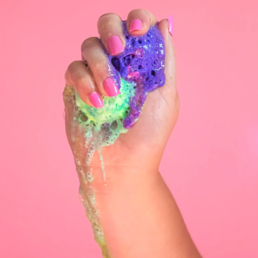 Hand squeezing colorful slime, screenshot from Sept 11, 2025