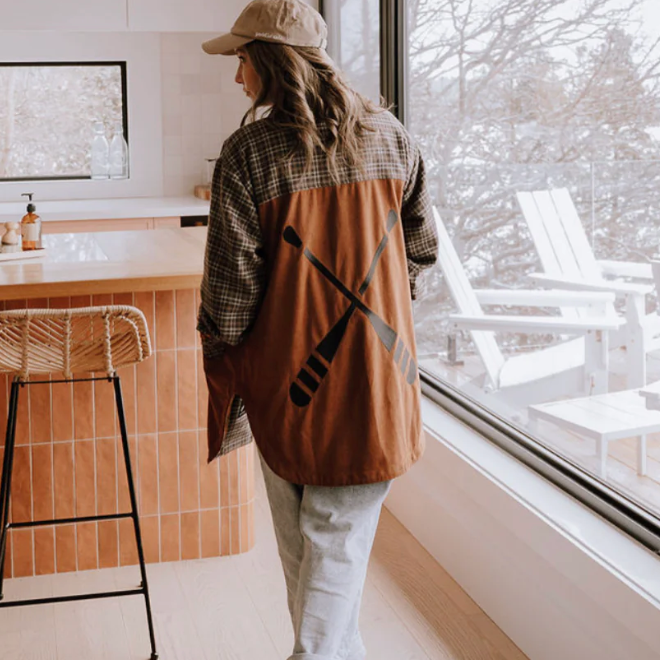 Woman in shirt with paddle design, screenshot Sept 12, 2025.