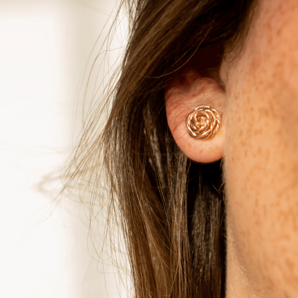 Rose stud earring on ear, screenshot Sept 15, 2025.