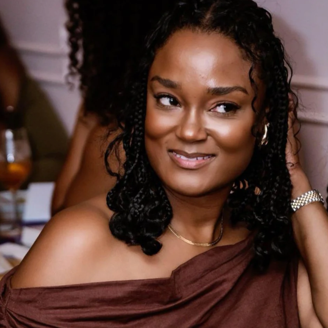 Woman with braids in brown dress, Sept 15, 2025 screenshot