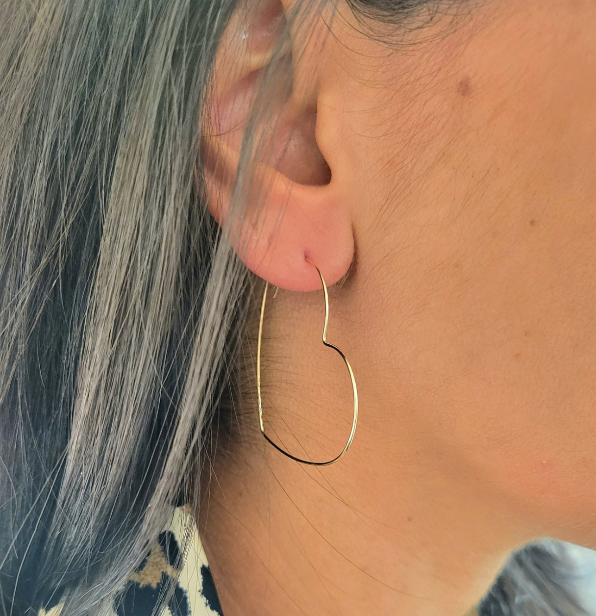 Heart-shaped gold hoop earring, screenshot from Sept 15, 2025