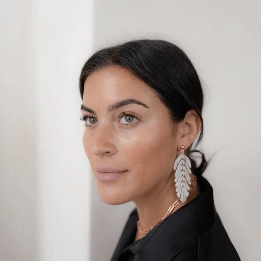 Woman wearing leaf earrings, Screenshot 2025-09-15