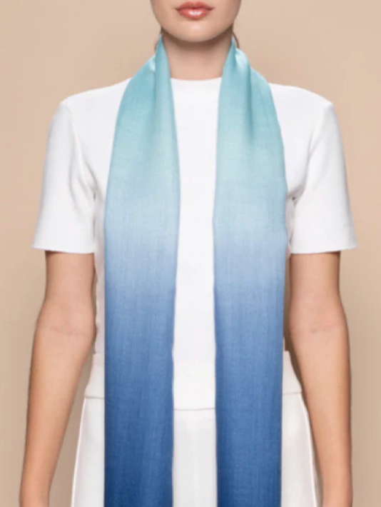 Woman wearing ombre blue scarf, screenshot 2025-09-15