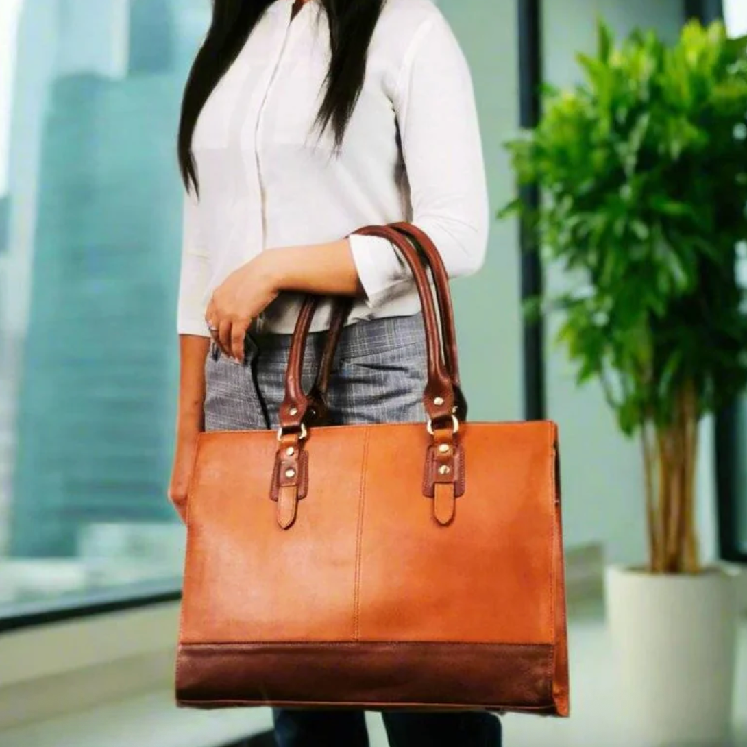 Woman holding brown leather laptop bag, Sept 18, 2025 screenshot