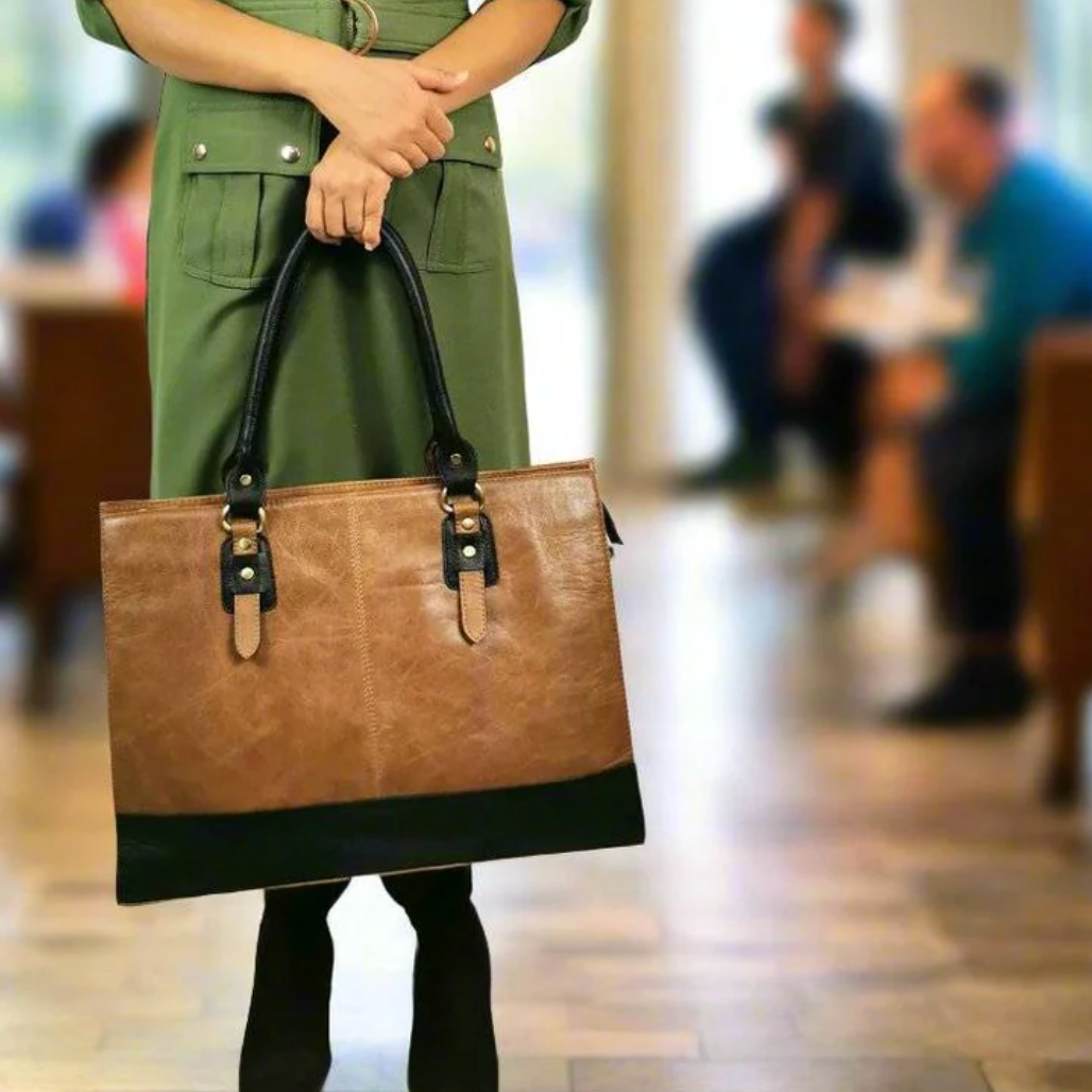 Woman holding leather tote bag, Screenshot Sept 18, 2025
