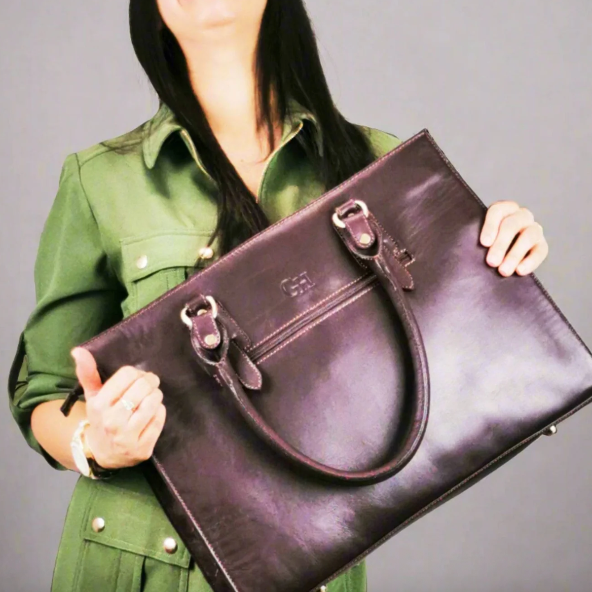 Woman holding a brown leather bag - Screenshot 2025-09-18