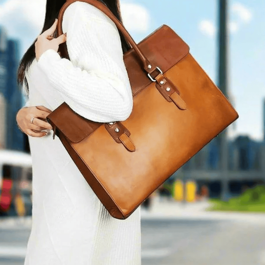 Woman holding brown leather bag, screenshot 2025-09-19