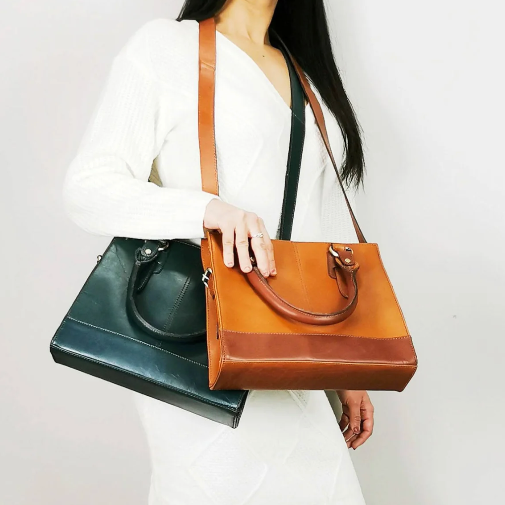 Woman holding two leather handbags, screenshot 2025-09-19.