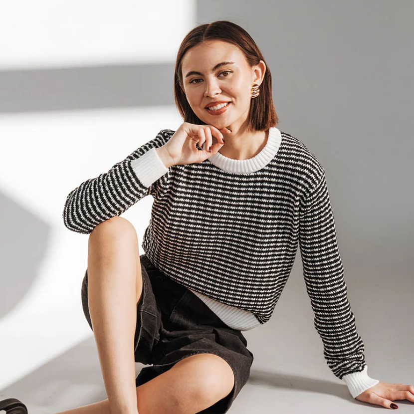 Woman in black and white sweater, Sept 20, 2025 screenshot.