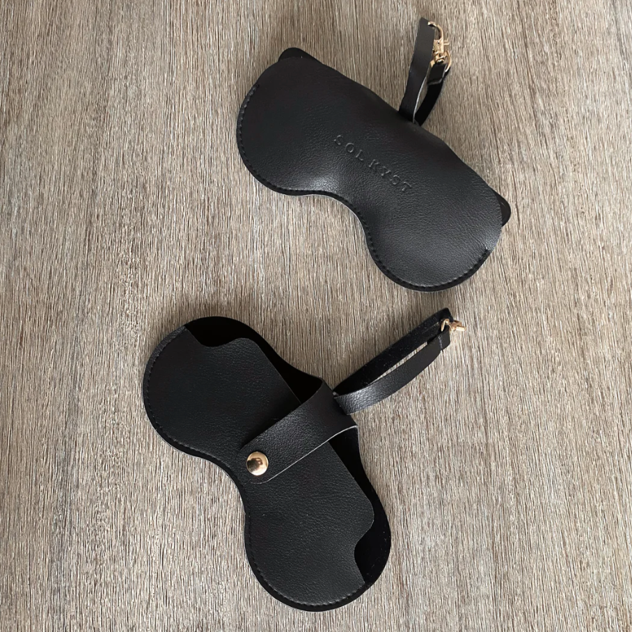 Black sunglasses cases on wooden surface, June 26, 2025