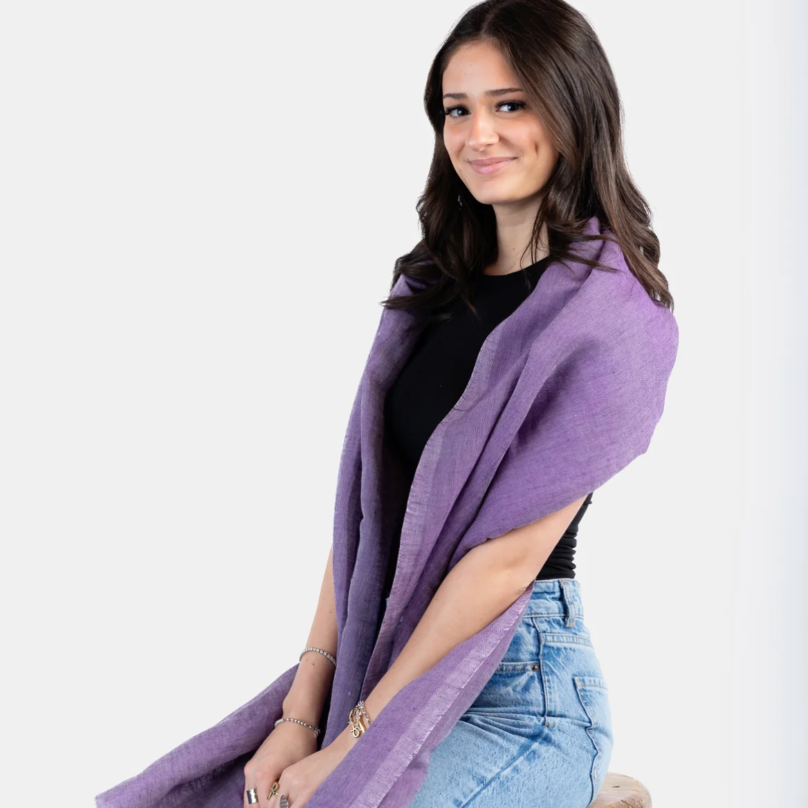 Woman wearing purple scarf, screenshot June 30, 2025.