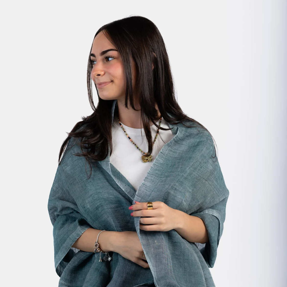 Woman wearing teal shawl, screenshot June 30, 2025.