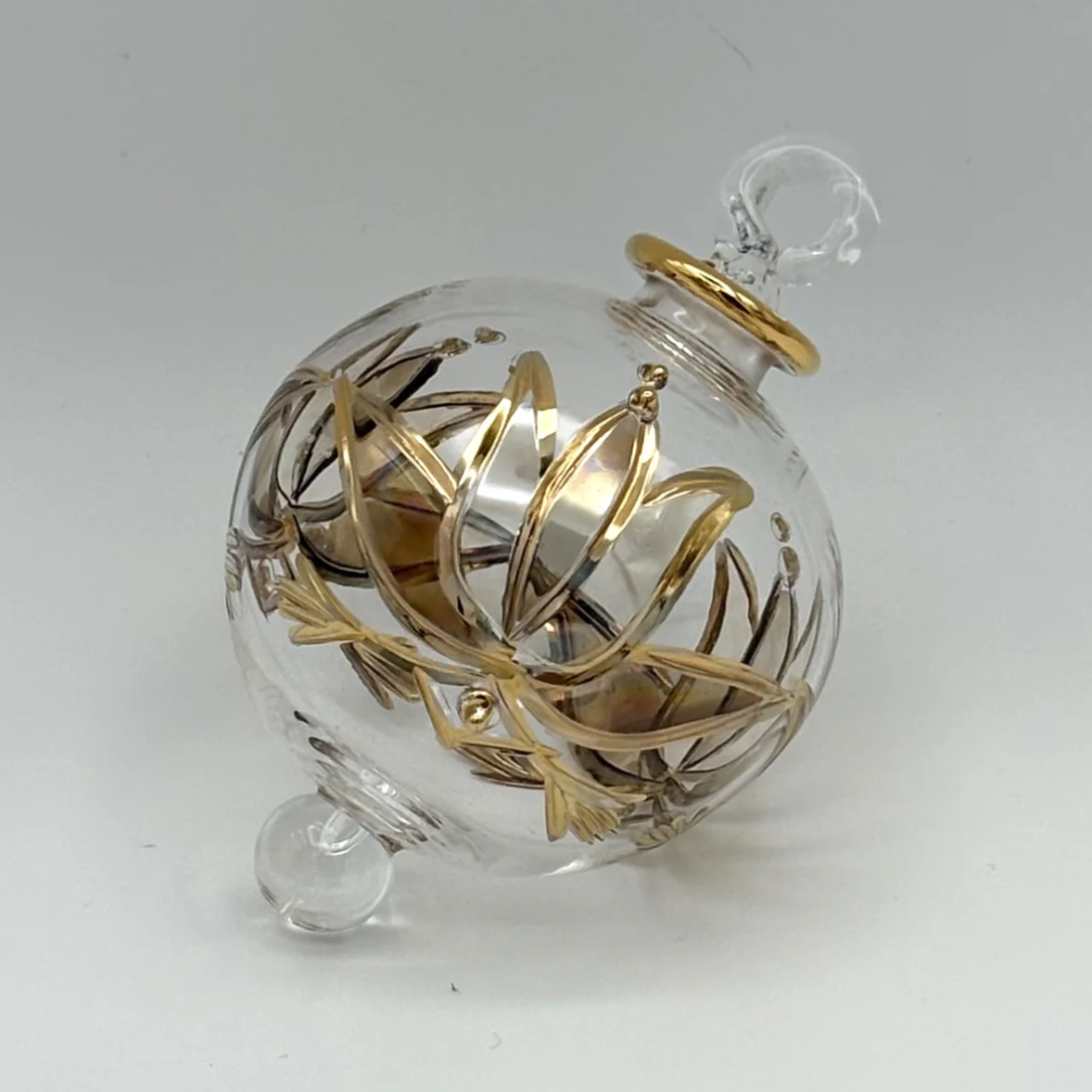 Glass ornament with gold design, screenshot June 30, 2025.