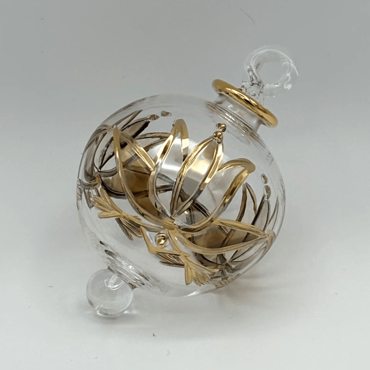 Glass ornament with gold design, screenshot June 30, 2025.