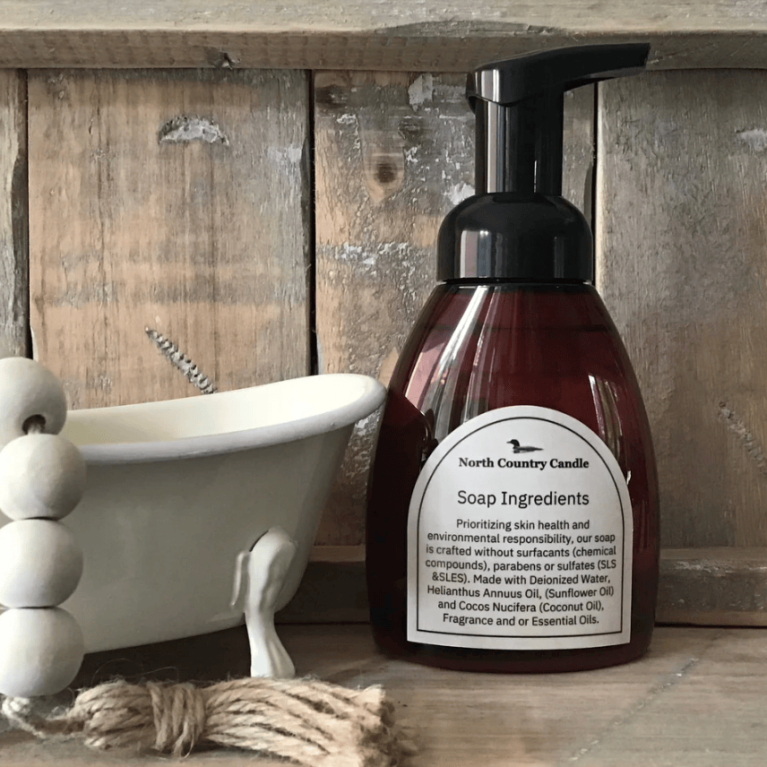 North Country Candle soap bottle next to a small bathtub.